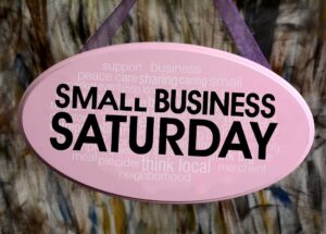 This is an image of a purple, oval sign that says "Small Business Saturday."